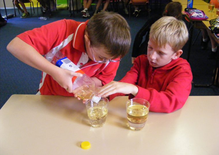 Two primary school students doing a science experiment together